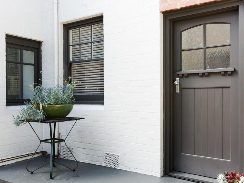 entryway with white painted brick