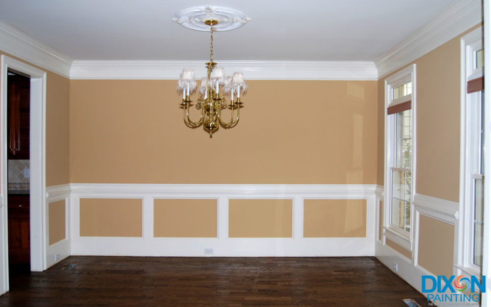 A stylish room adorned with a luxurious chandelier and white trim