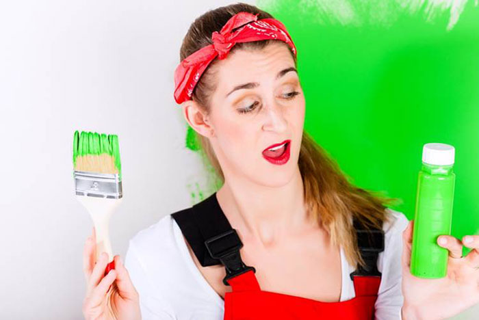 a girl holding a paint brush