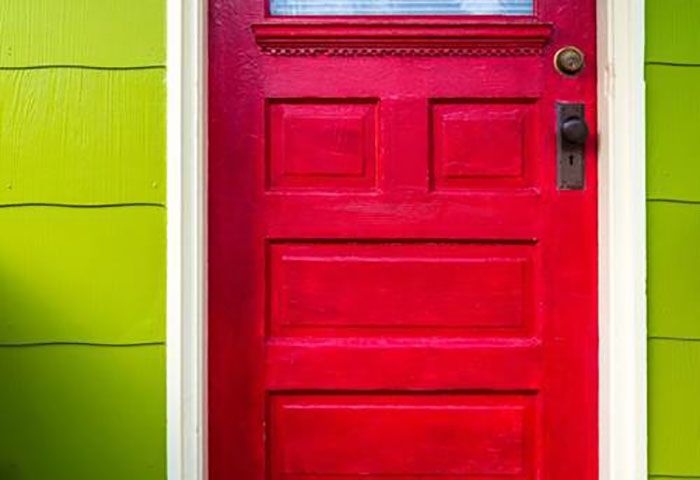 a red door with a green wall