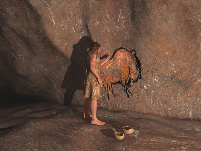 a stone age man painting on the wall 