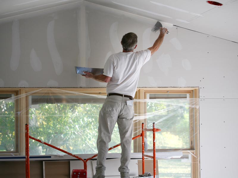 man spackling drywall